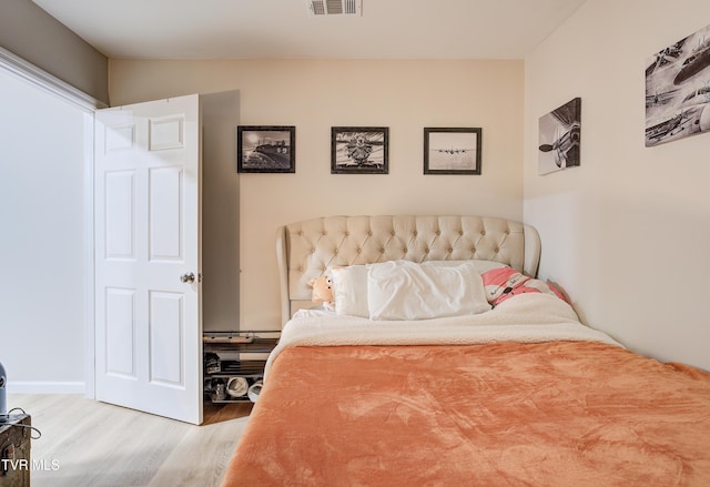 bedroom with hardwood / wood-style flooring