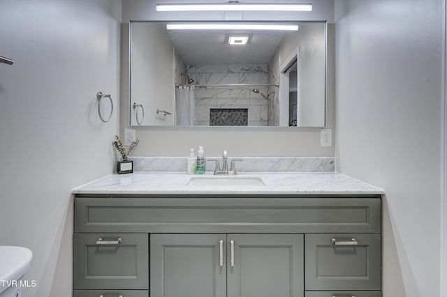 bathroom featuring vanity, toilet, and curtained shower