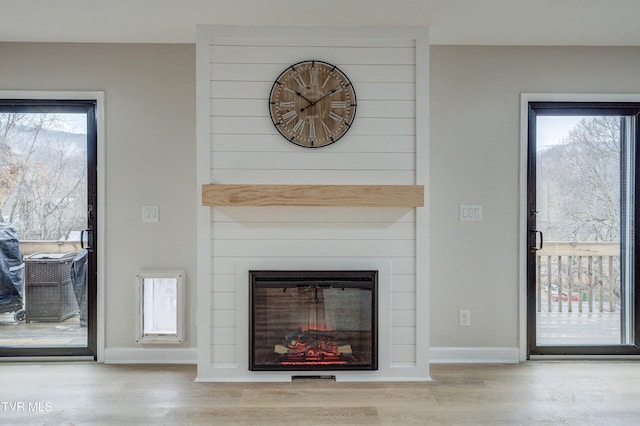 unfurnished living room featuring a fireplace and light hardwood / wood-style floors