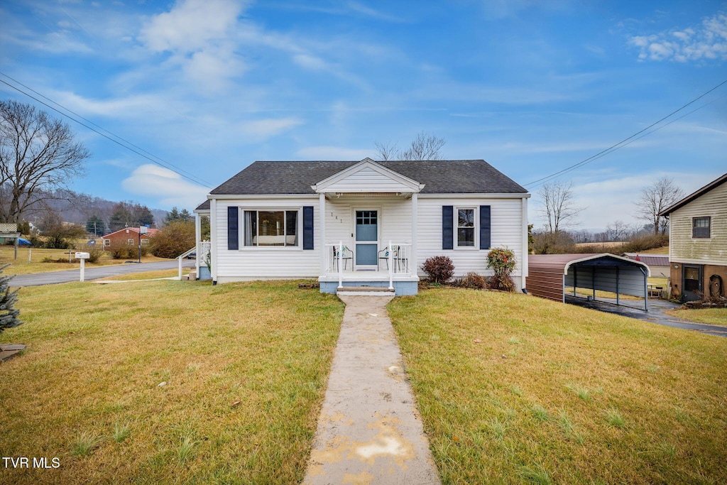 bungalow-style home with a carport and a front lawn