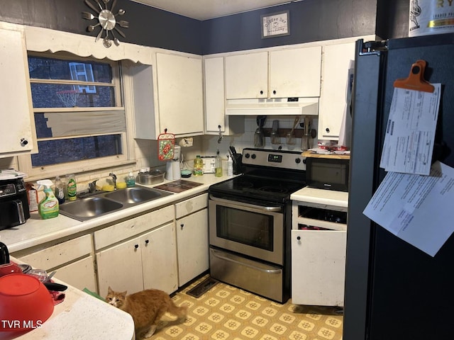 kitchen with white cabinetry, stainless steel electric range oven, sink, and decorative backsplash