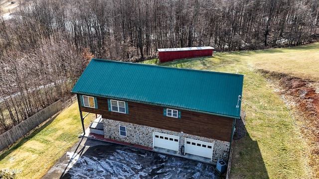 view of side of property with an outbuilding and a lawn