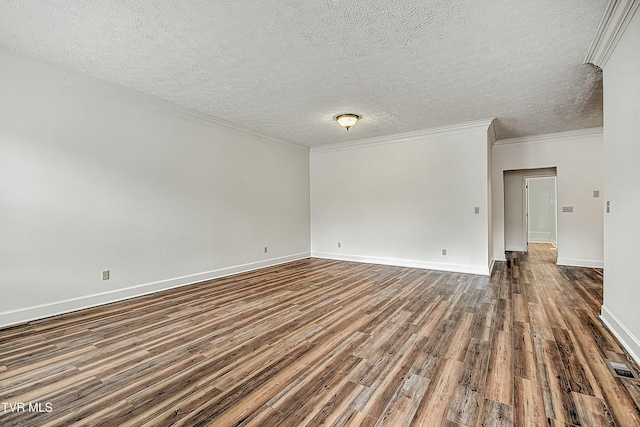 spare room featuring ornamental molding, dark hardwood / wood-style floors, and a textured ceiling