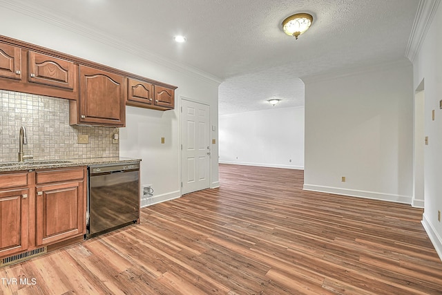 kitchen featuring dishwasher, sink, crown molding, light stone countertops, and dark wood-type flooring