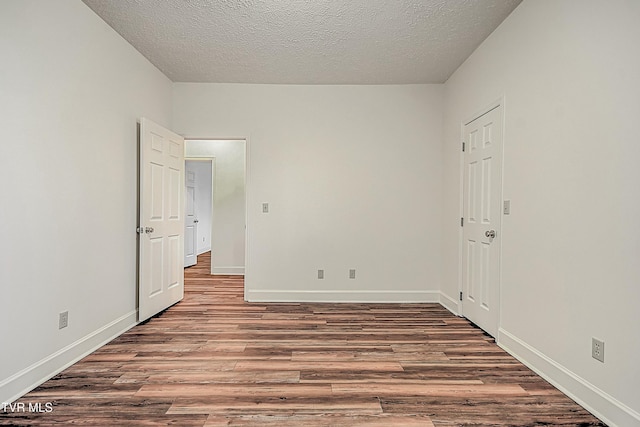 unfurnished bedroom with hardwood / wood-style floors and a textured ceiling