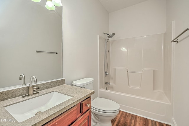 full bathroom featuring vanity, wood-type flooring, shower / bathtub combination, and toilet