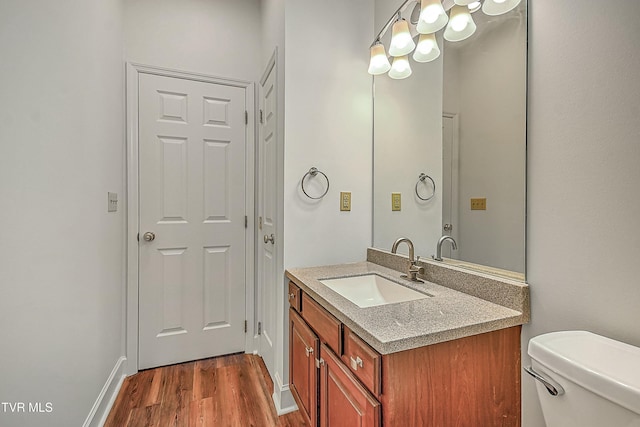 bathroom with vanity, hardwood / wood-style floors, and toilet