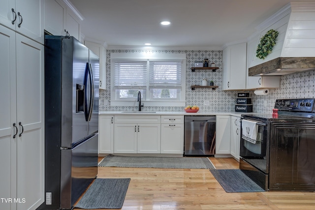 kitchen with sink, appliances with stainless steel finishes, white cabinetry, decorative backsplash, and custom exhaust hood