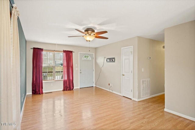 foyer with ceiling fan and light hardwood / wood-style floors