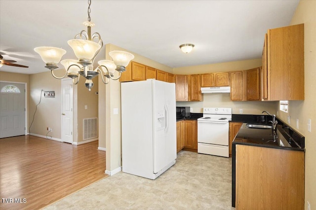 kitchen with ceiling fan with notable chandelier, white appliances, decorative light fixtures, and sink