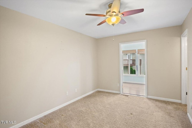 carpeted spare room featuring ceiling fan