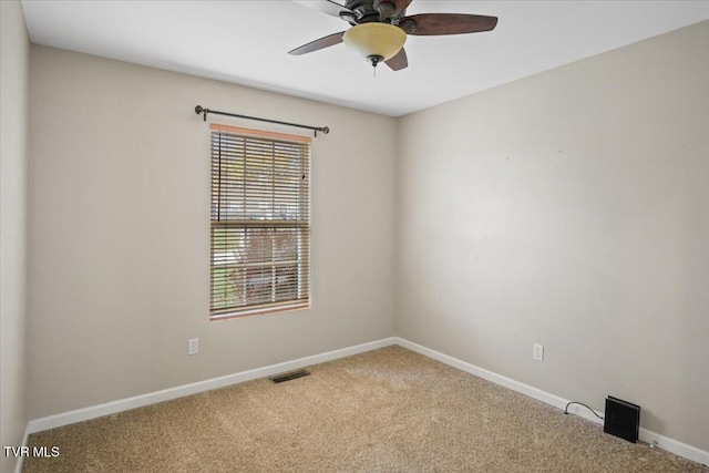 carpeted empty room featuring ceiling fan