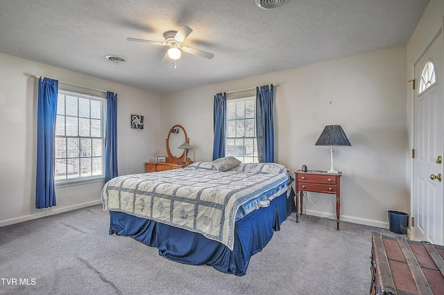 bedroom featuring carpet floors, a textured ceiling, and ceiling fan