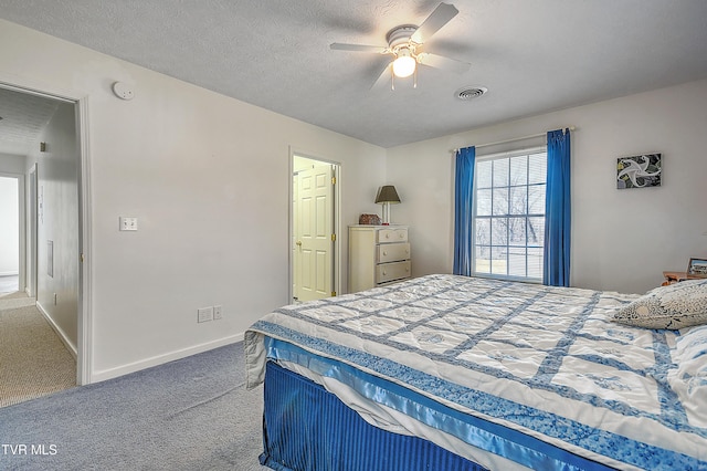 bedroom featuring ceiling fan, carpet flooring, and a textured ceiling