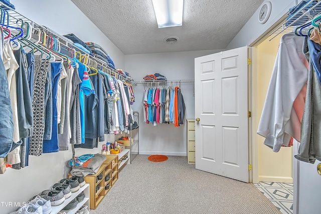 walk in closet featuring carpet