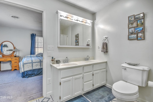 bathroom with vanity, a textured ceiling, and toilet