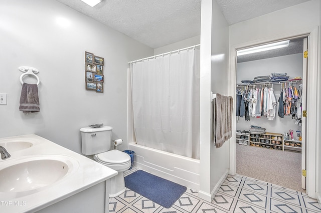 full bathroom with vanity, shower / tub combo, a textured ceiling, and toilet