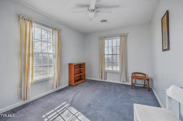 unfurnished room with ceiling fan and carpet flooring