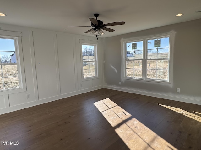 unfurnished room featuring dark wood-type flooring and ceiling fan