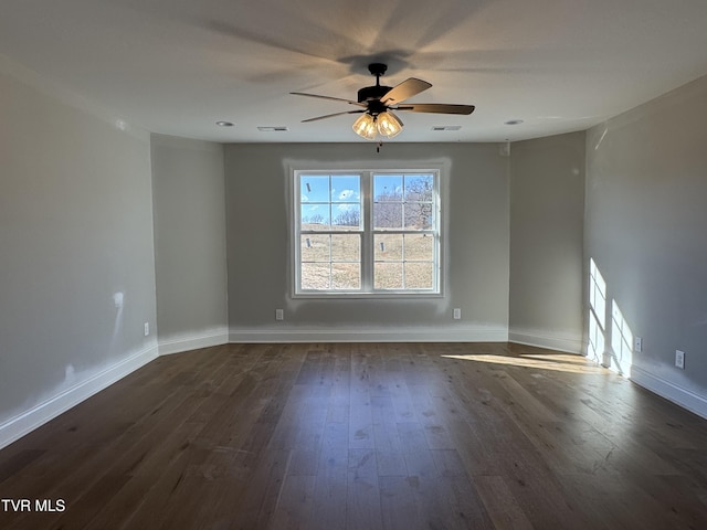 spare room featuring ceiling fan and dark hardwood / wood-style flooring