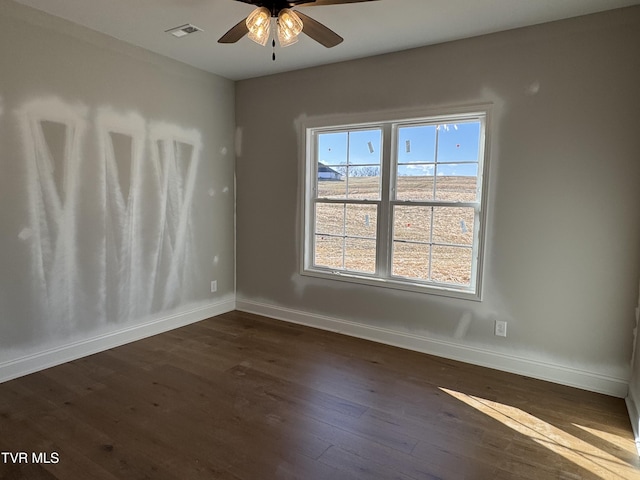 unfurnished room with dark hardwood / wood-style floors and ceiling fan