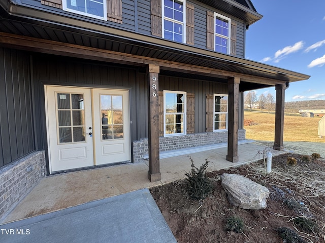 doorway to property featuring french doors and a porch