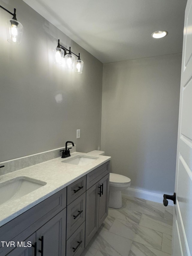 bathroom with toilet and vanity