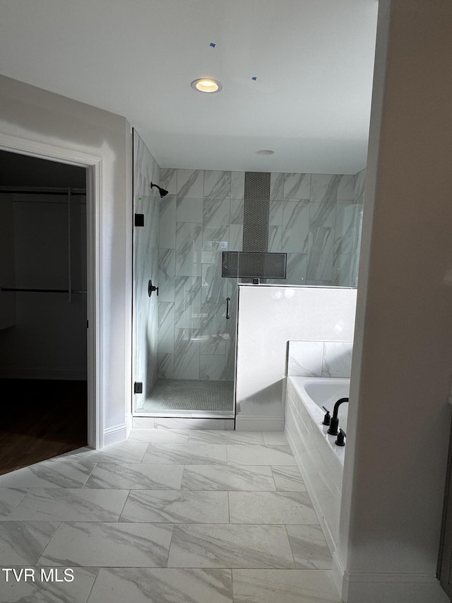 bathroom with shower with separate bathtub