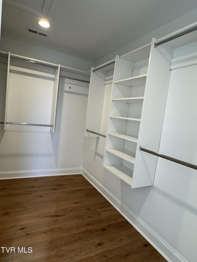 walk in closet featuring dark hardwood / wood-style floors