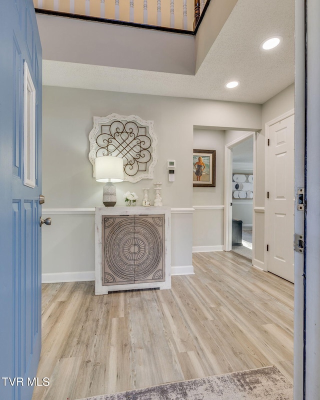 entryway featuring light hardwood / wood-style floors and a textured ceiling