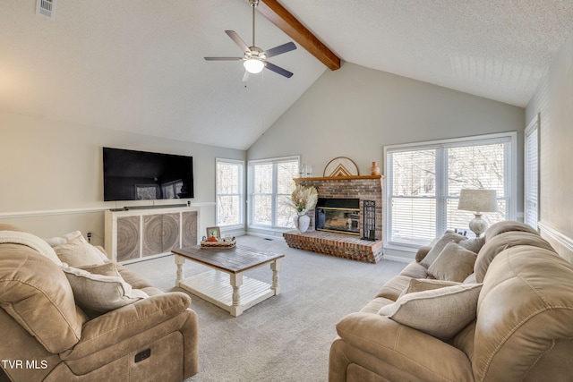 living room with beamed ceiling, a wealth of natural light, light colored carpet, and a fireplace