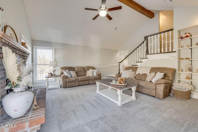 carpeted living room with ceiling fan, high vaulted ceiling, and beam ceiling