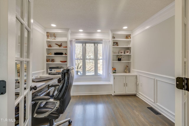 office featuring ornamental molding, light hardwood / wood-style floors, and a textured ceiling