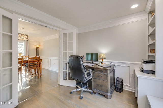 office space with french doors, ornamental molding, and light hardwood / wood-style flooring