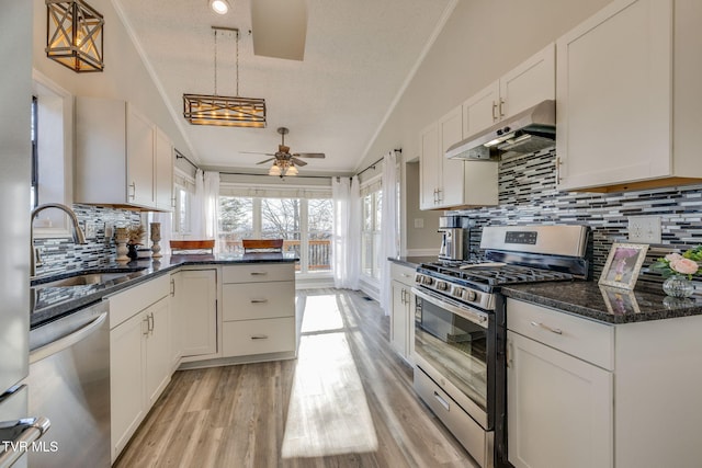 kitchen with sink, decorative light fixtures, white cabinets, and appliances with stainless steel finishes