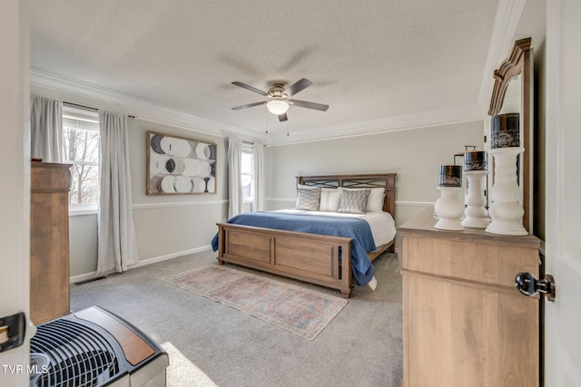 carpeted bedroom featuring ceiling fan, ornamental molding, and a textured ceiling