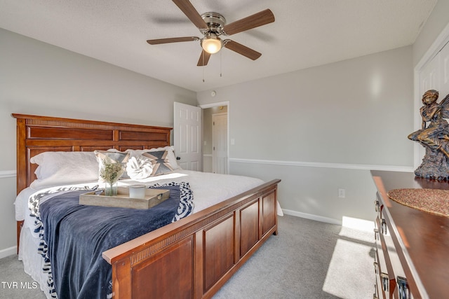 bedroom featuring light colored carpet and ceiling fan