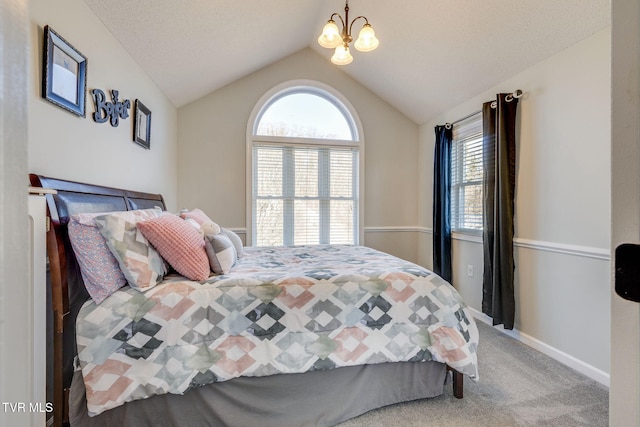 carpeted bedroom with lofted ceiling and a notable chandelier