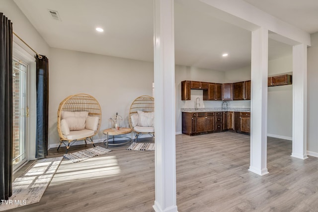 interior space featuring sink and light hardwood / wood-style floors