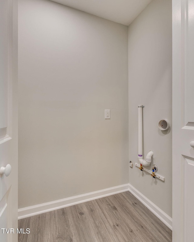 laundry area featuring light wood-type flooring