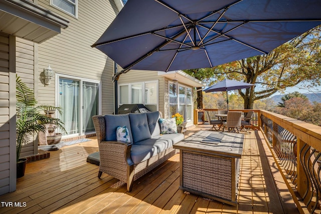 wooden terrace with an outdoor living space