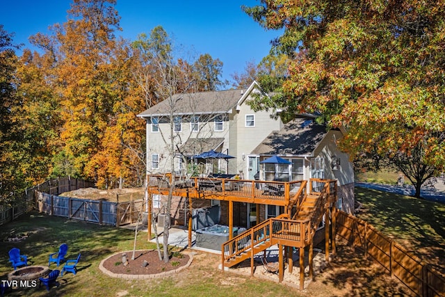 back of house with a wooden deck and a lawn