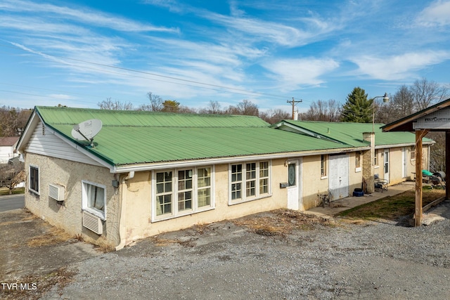 view of side of property featuring a wall mounted air conditioner