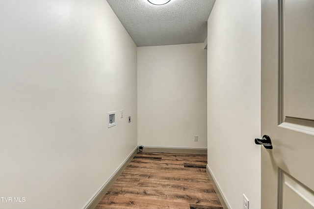 laundry area featuring washer hookup, hookup for an electric dryer, wood-type flooring, and a textured ceiling