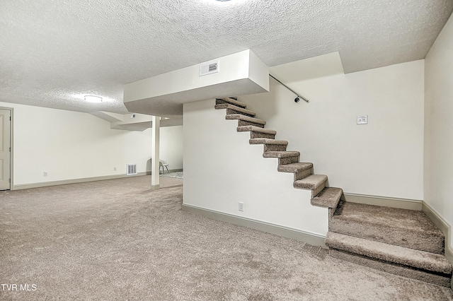 basement with light carpet and a textured ceiling