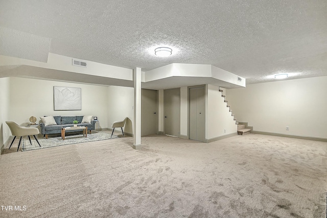 basement featuring carpet floors and a textured ceiling