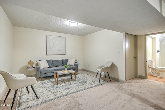 carpeted living room featuring a textured ceiling