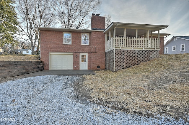 back of property featuring a garage