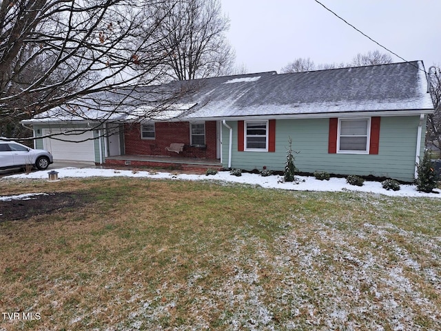 ranch-style house featuring a front yard, brick siding, an attached garage, and roof with shingles