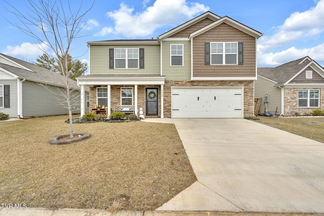 view of front of house featuring a garage, a front lawn, and covered porch